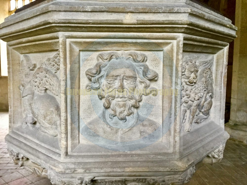 The baptismal font at St Mary’s Church in East Ruston, Norfolk, dates from the 14th or 15th century. While the main structure of the font is medieval, it underwent significant restoration in 1884.  Wikipedia Wikipedia  +1 Key details about the font include: Design: It is an octagonal stone bowl set on a stem surrounded by carvings of "grotesque beasts" or demons. Carvings: The bowl panels feature carvings of the Four Evangelists (an eagle, lion, man, and ox) alternating with human heads. Restoration: Although medieval in origin, the carvings were heavily recut or restored in the 19th century. Position: The font is located at the west end of the church, under the tower